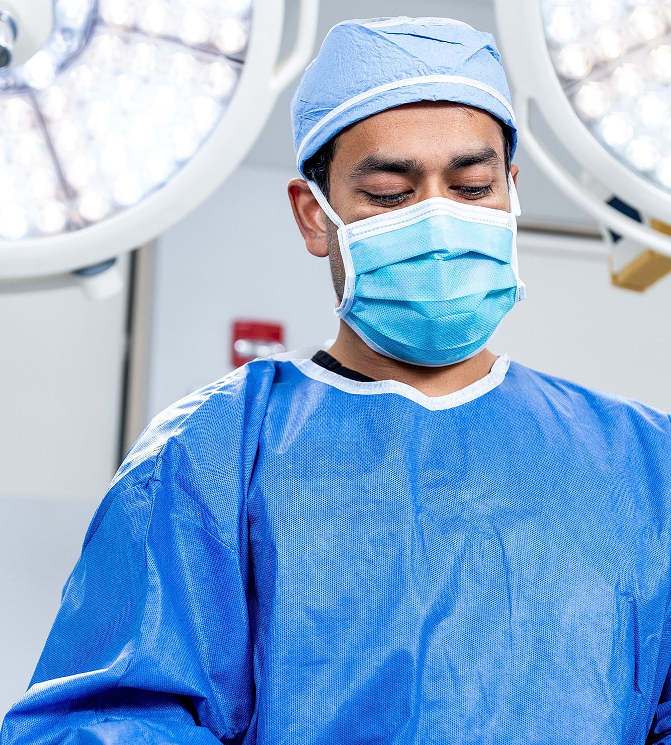 Surgeon performing a procedure in an operating room.