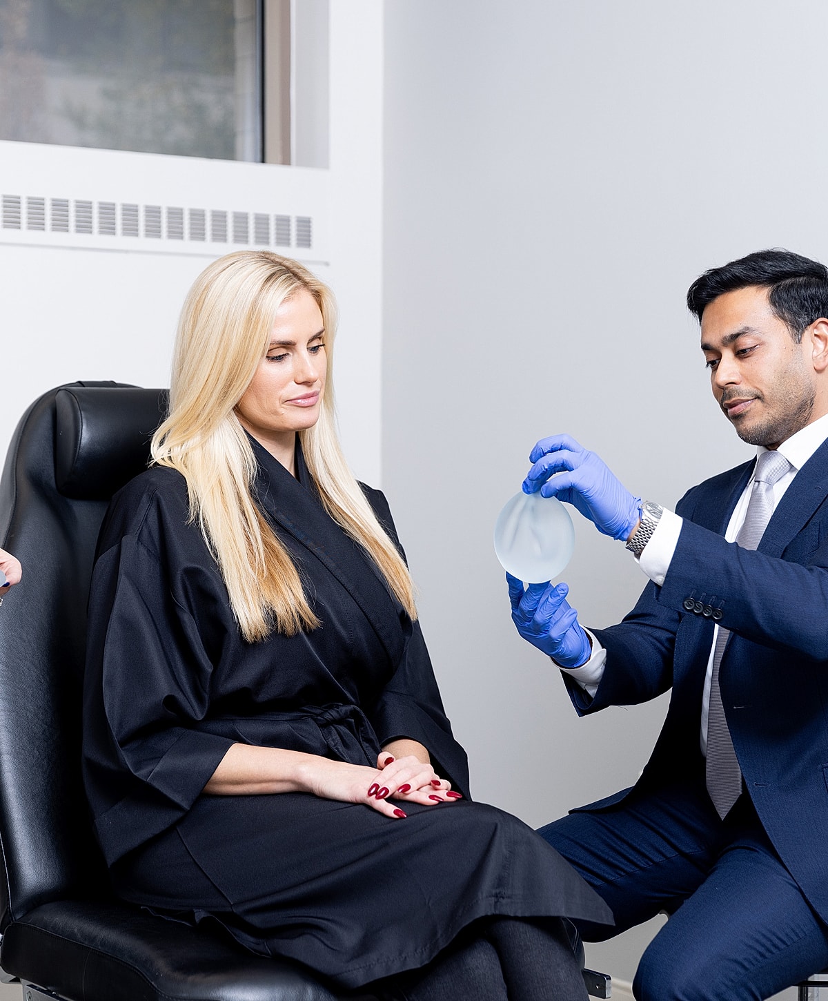 Consultation for breast implant procedure in clinic.