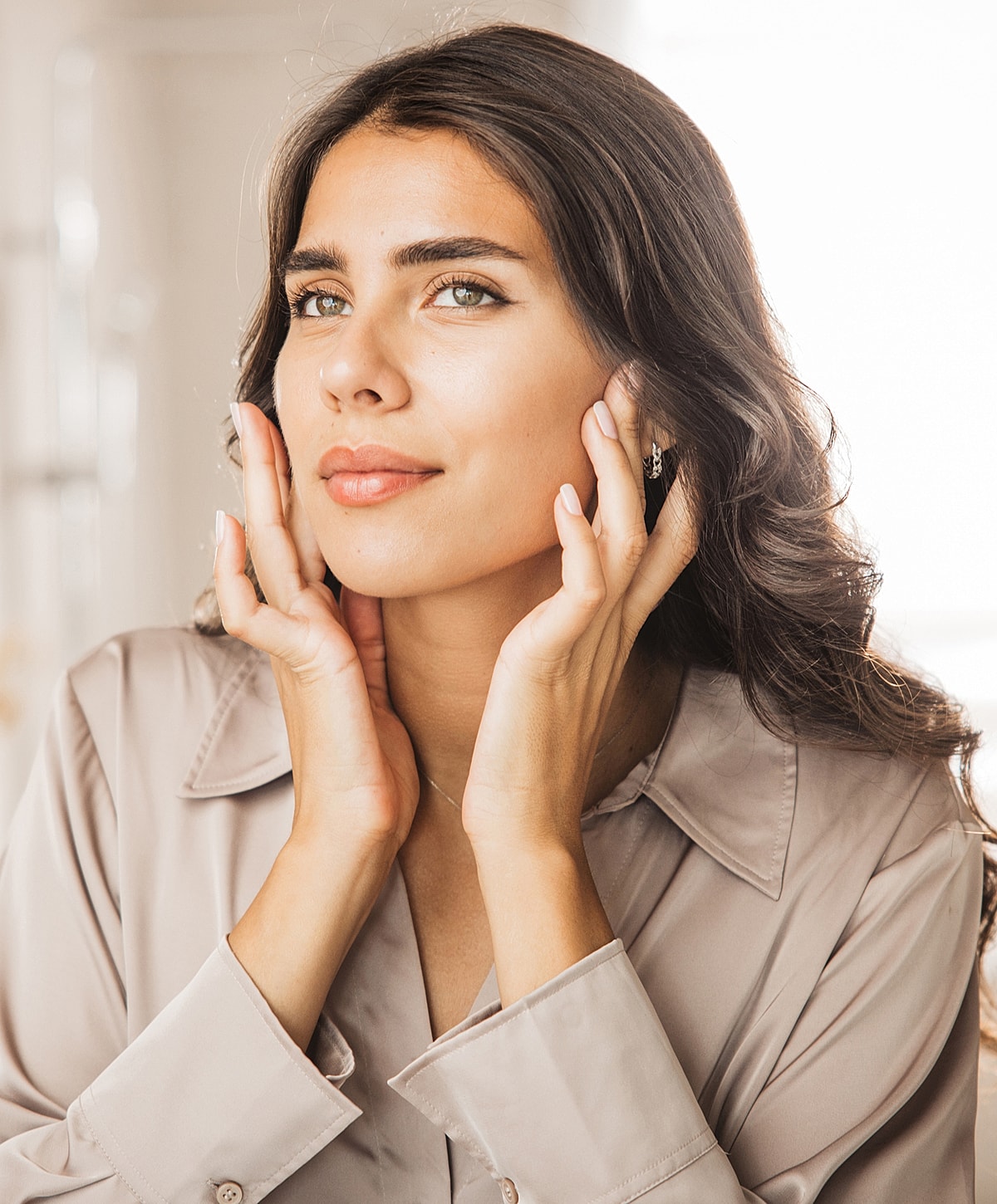 Young woman with long hair in soft light.