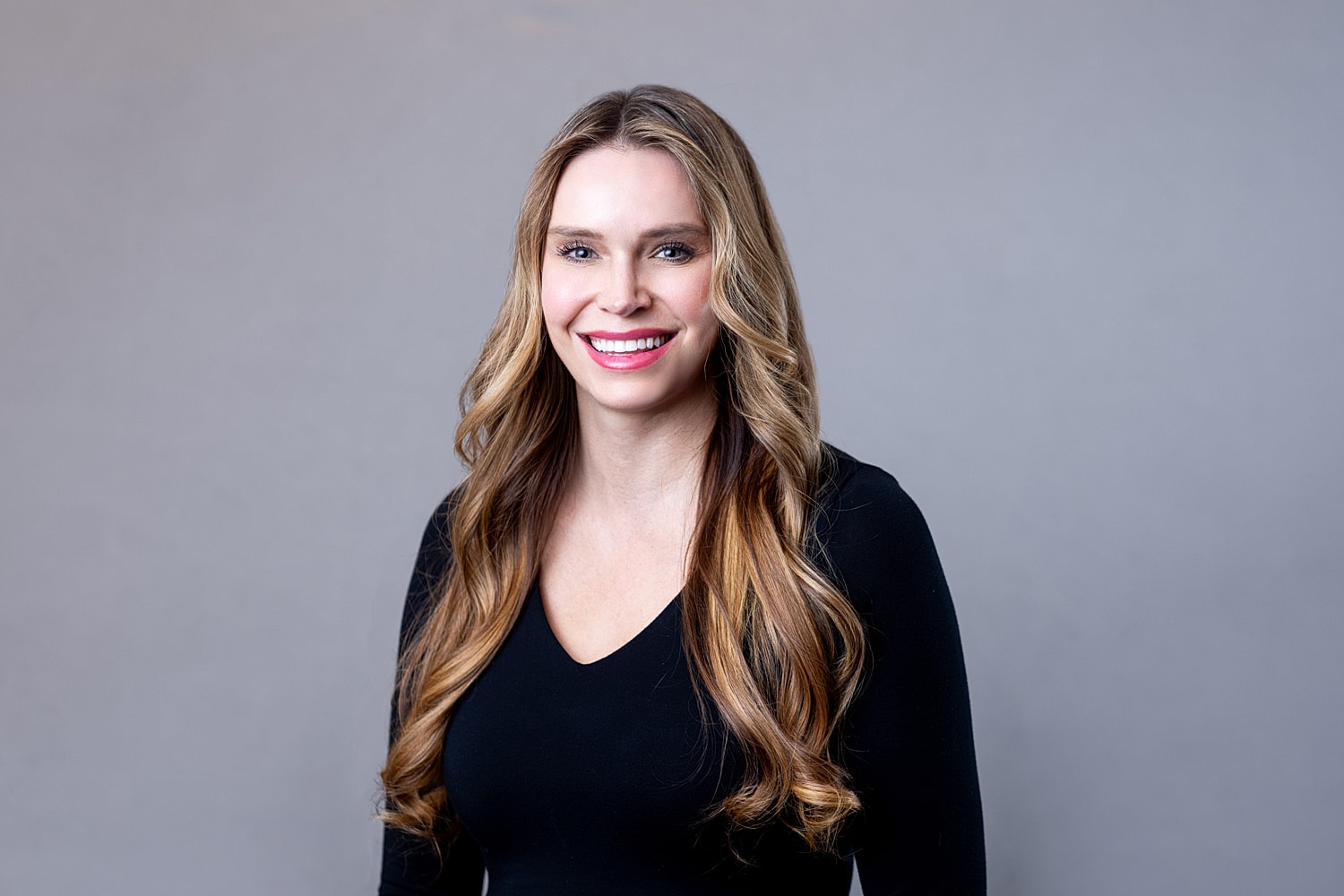 Smiling woman with long hair in black top