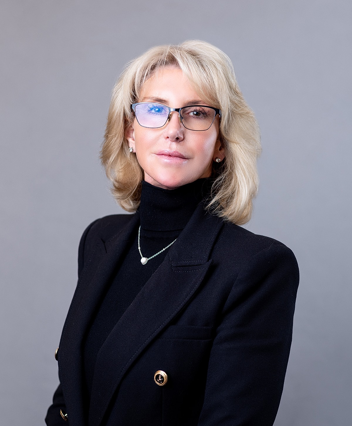 Professional woman in a black blazer portrait.