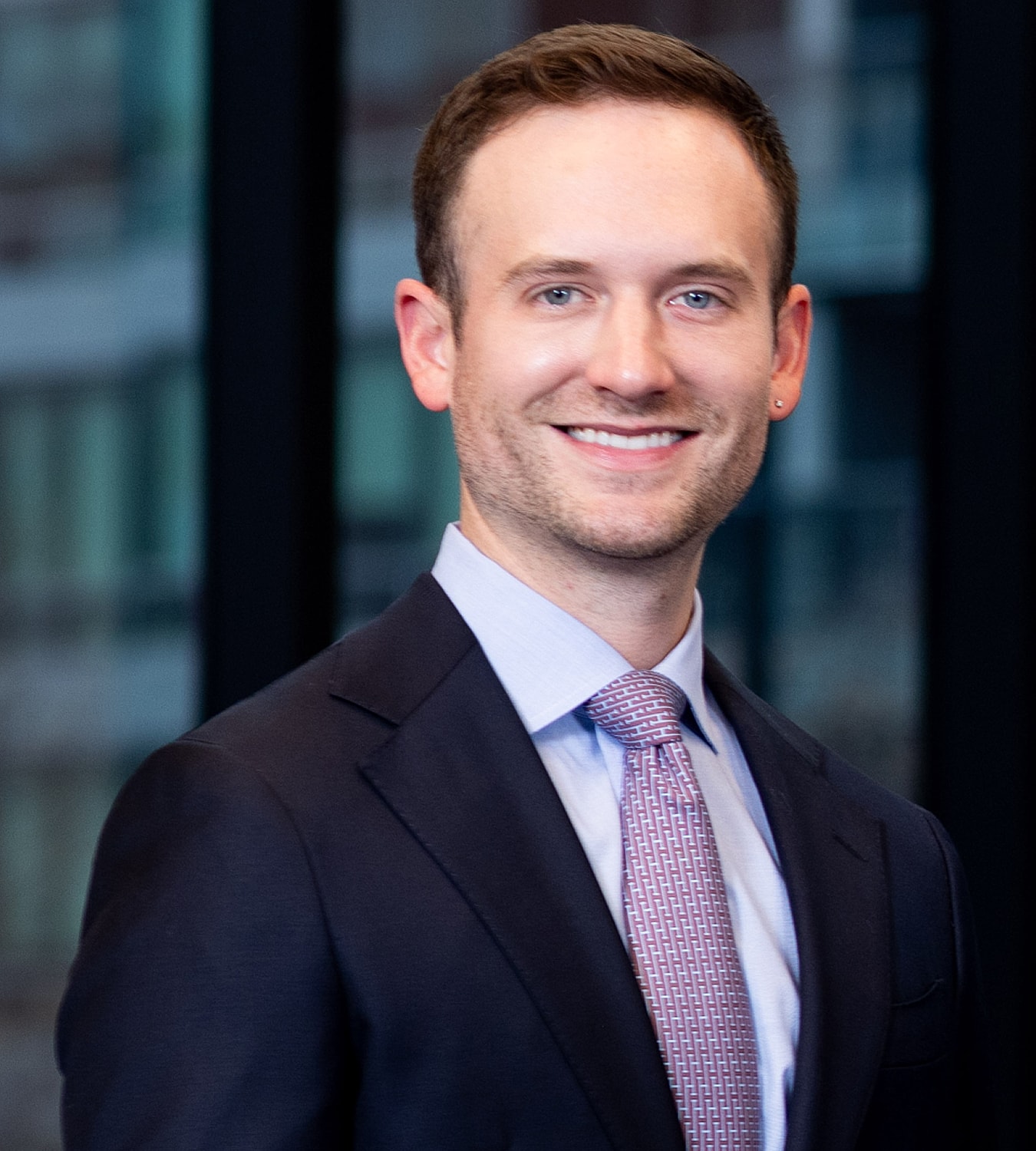 Smiling man in a professional suit portrait.