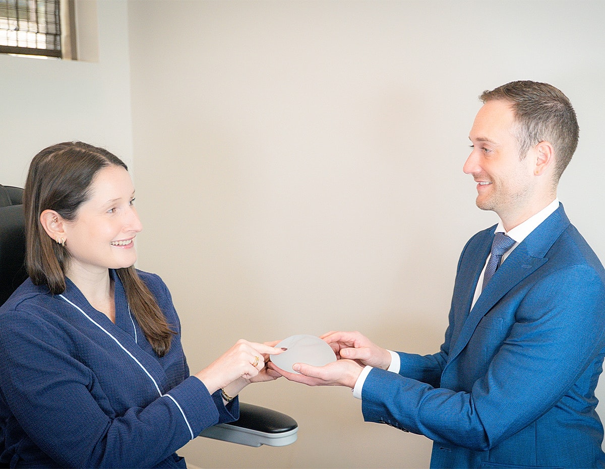 Patient discussing breast implant options with doctor.