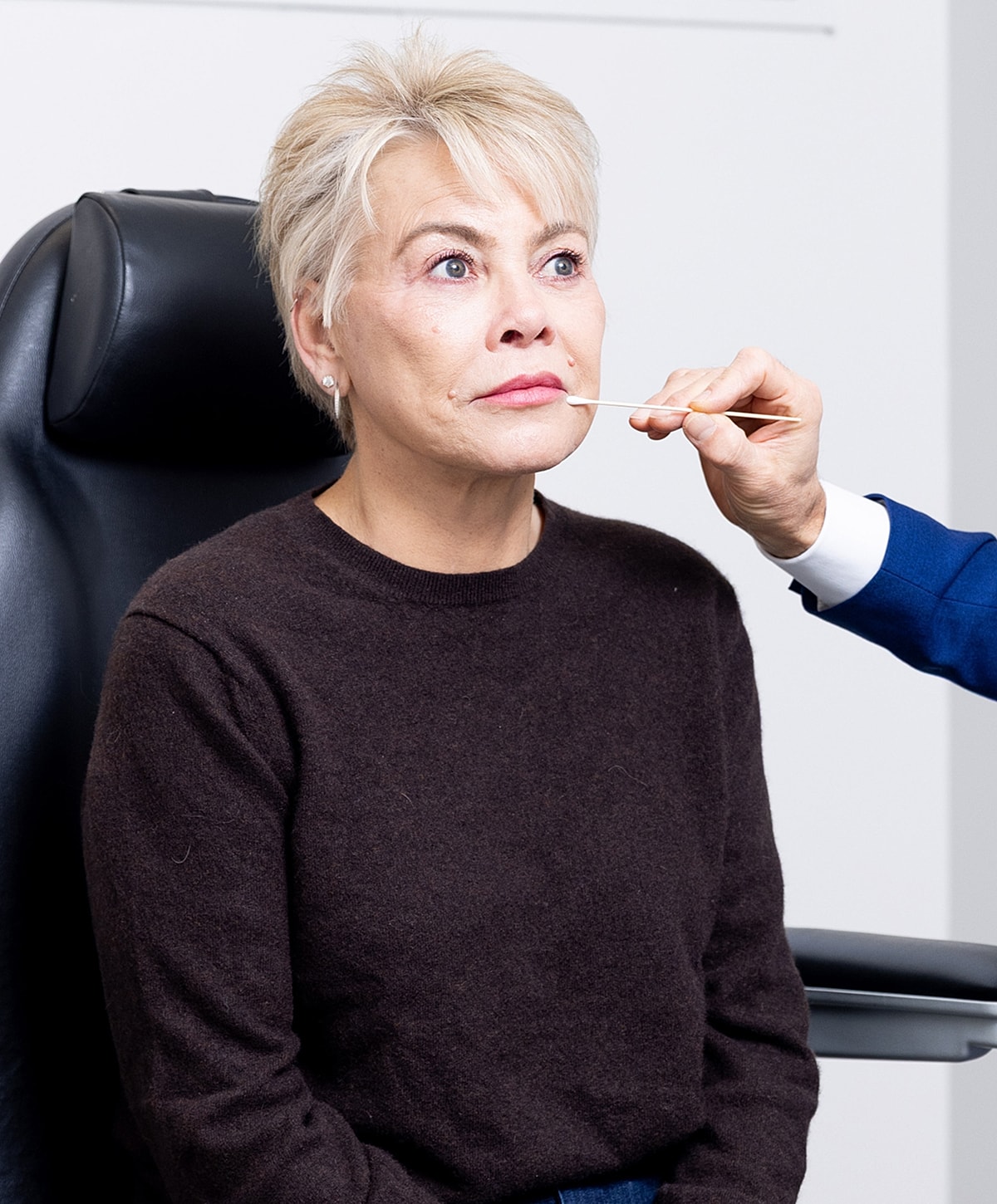 Woman receiving cosmetic treatment in clinic setting.