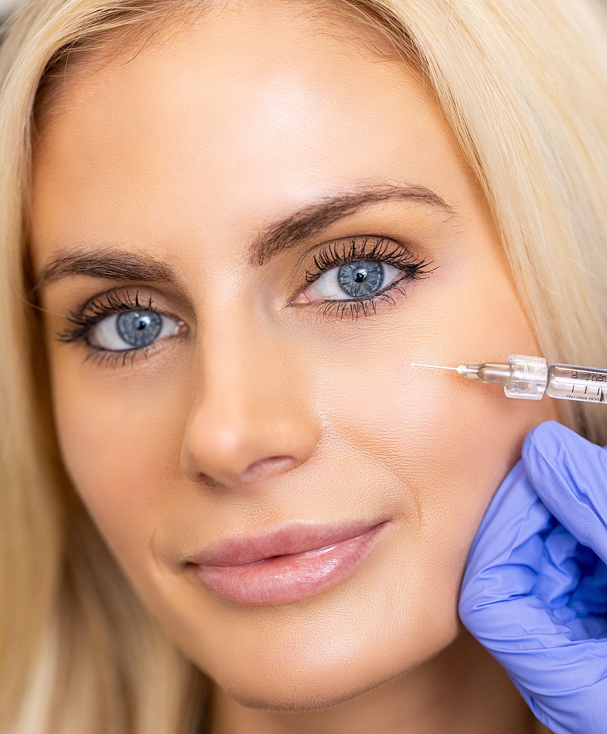Woman receiving an injection for cosmetic treatment.