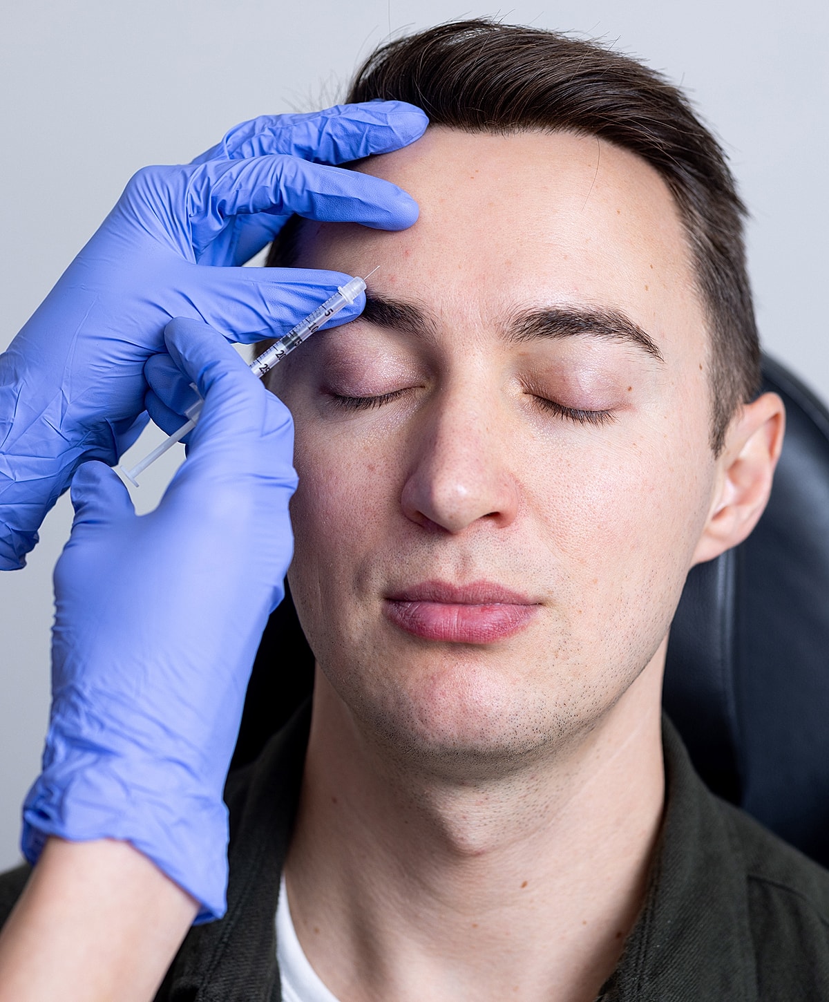 Administering an injection for cosmetic treatment.