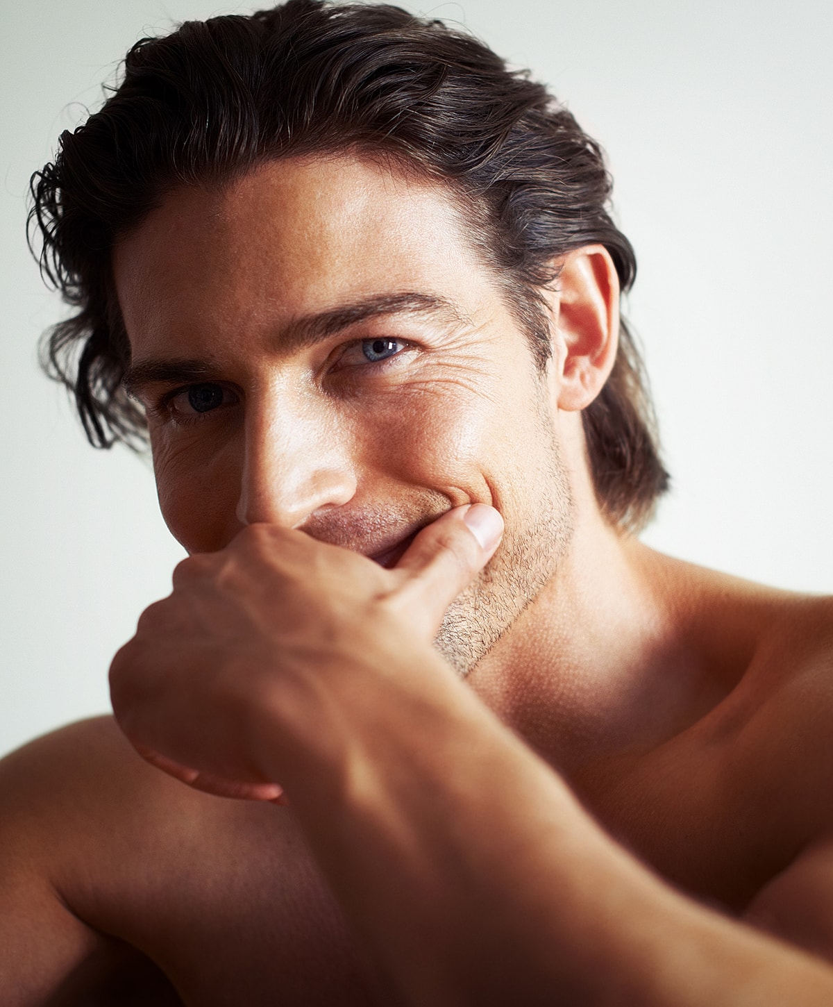 Man smiling with hand on chin, portrait shot.