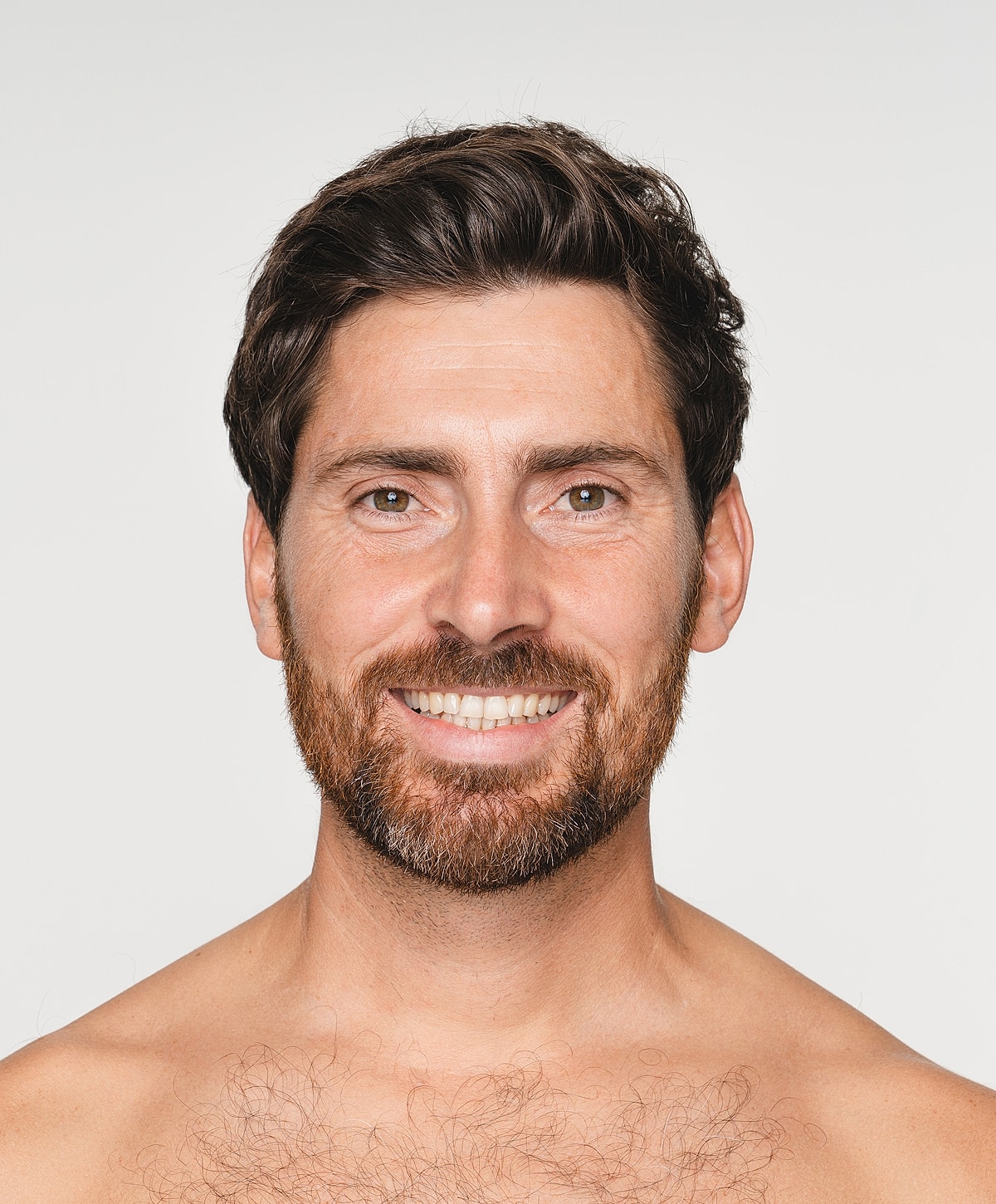 Smiling man with beard against plain background