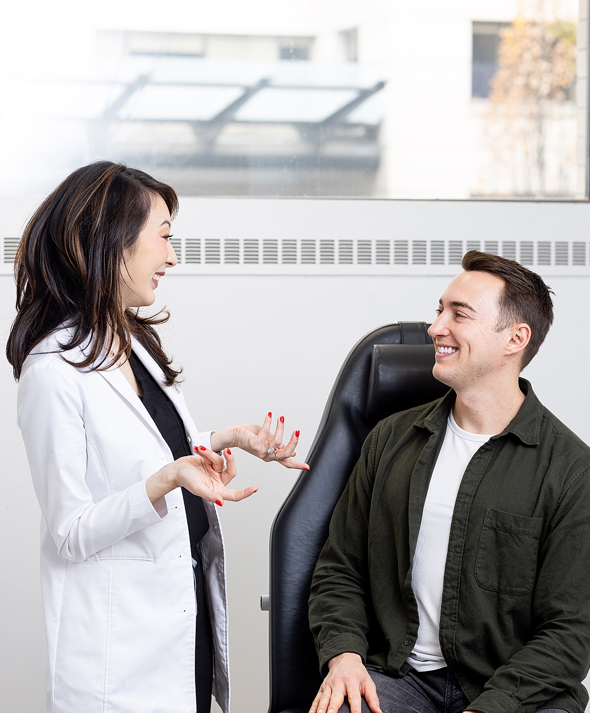 Doctor consulting with patient in clinic setting.