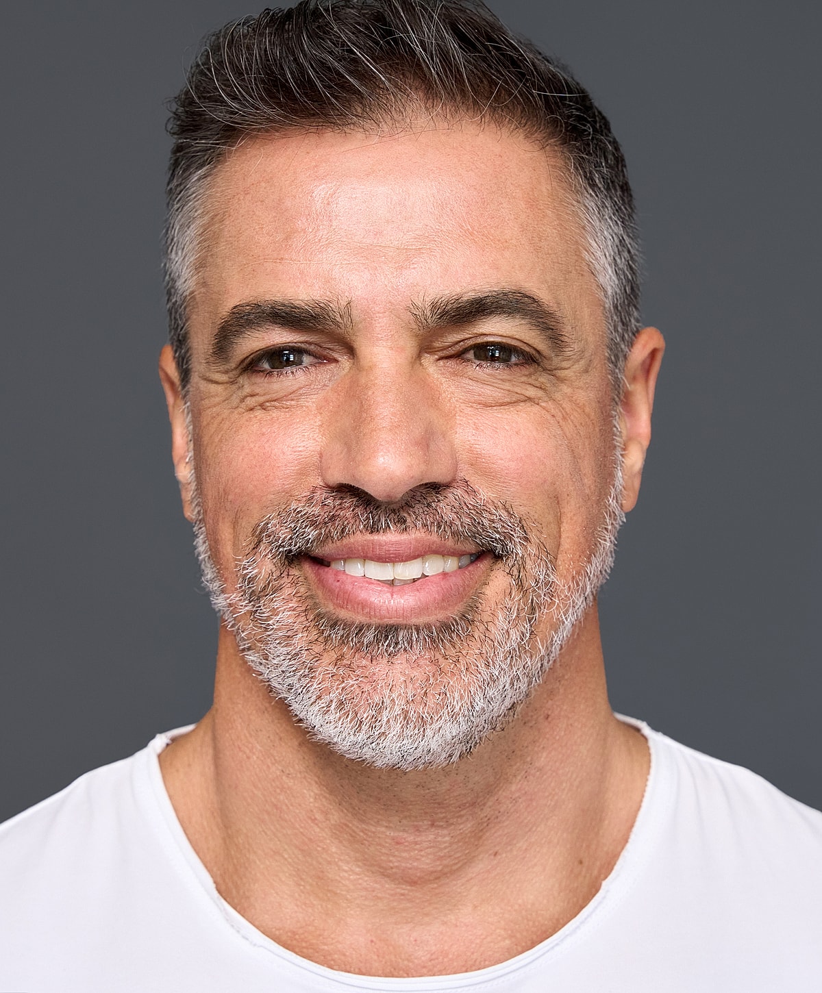 Smiling man with short hair and beard.