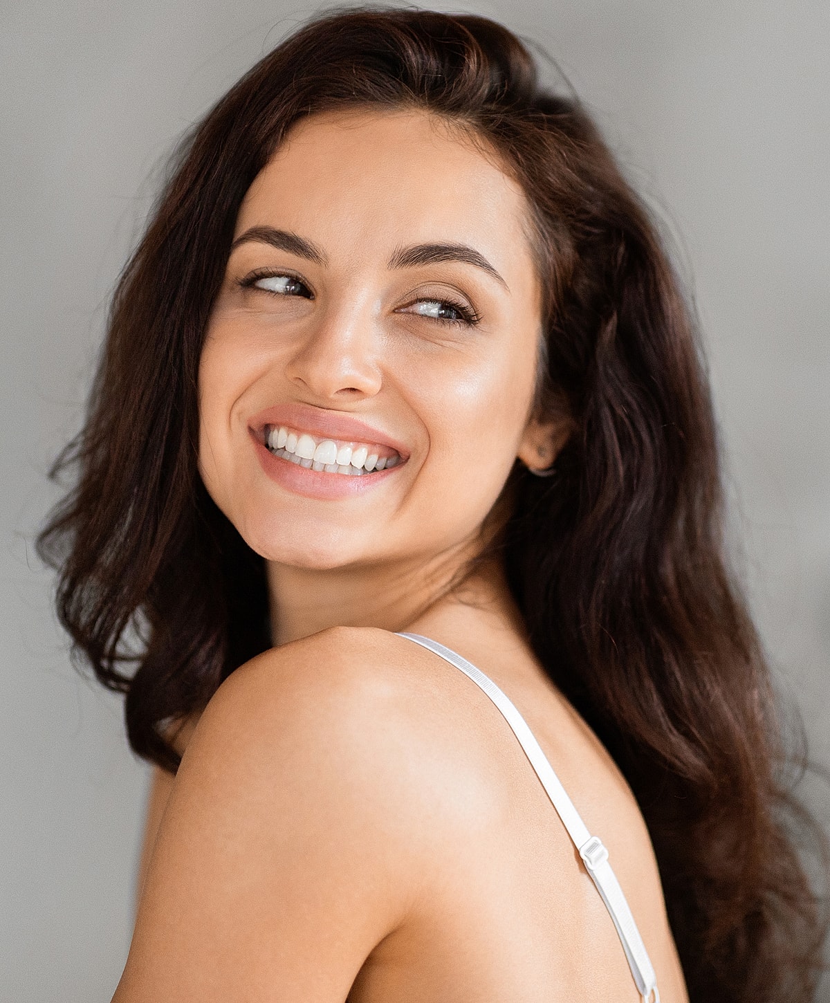 Smiling woman with long, dark hair.