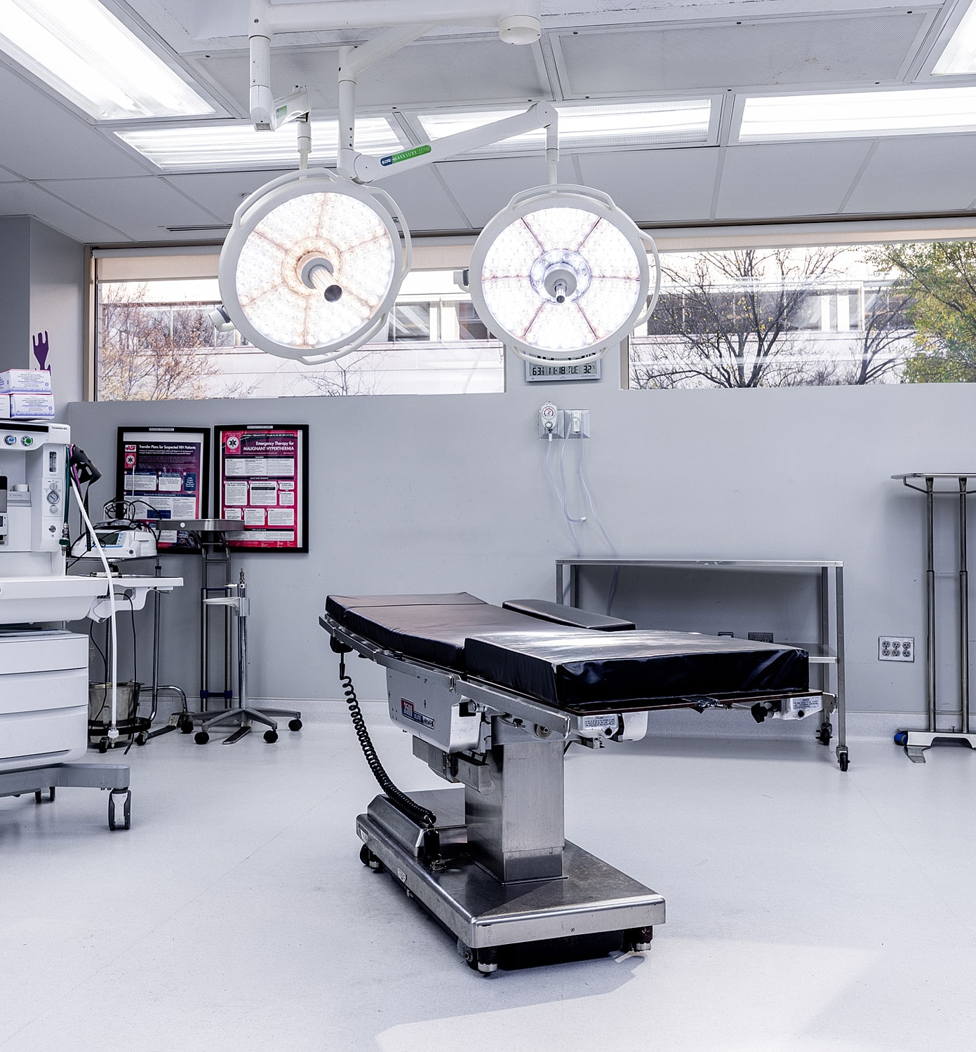 Modern surgical theater with equipment and lighting.