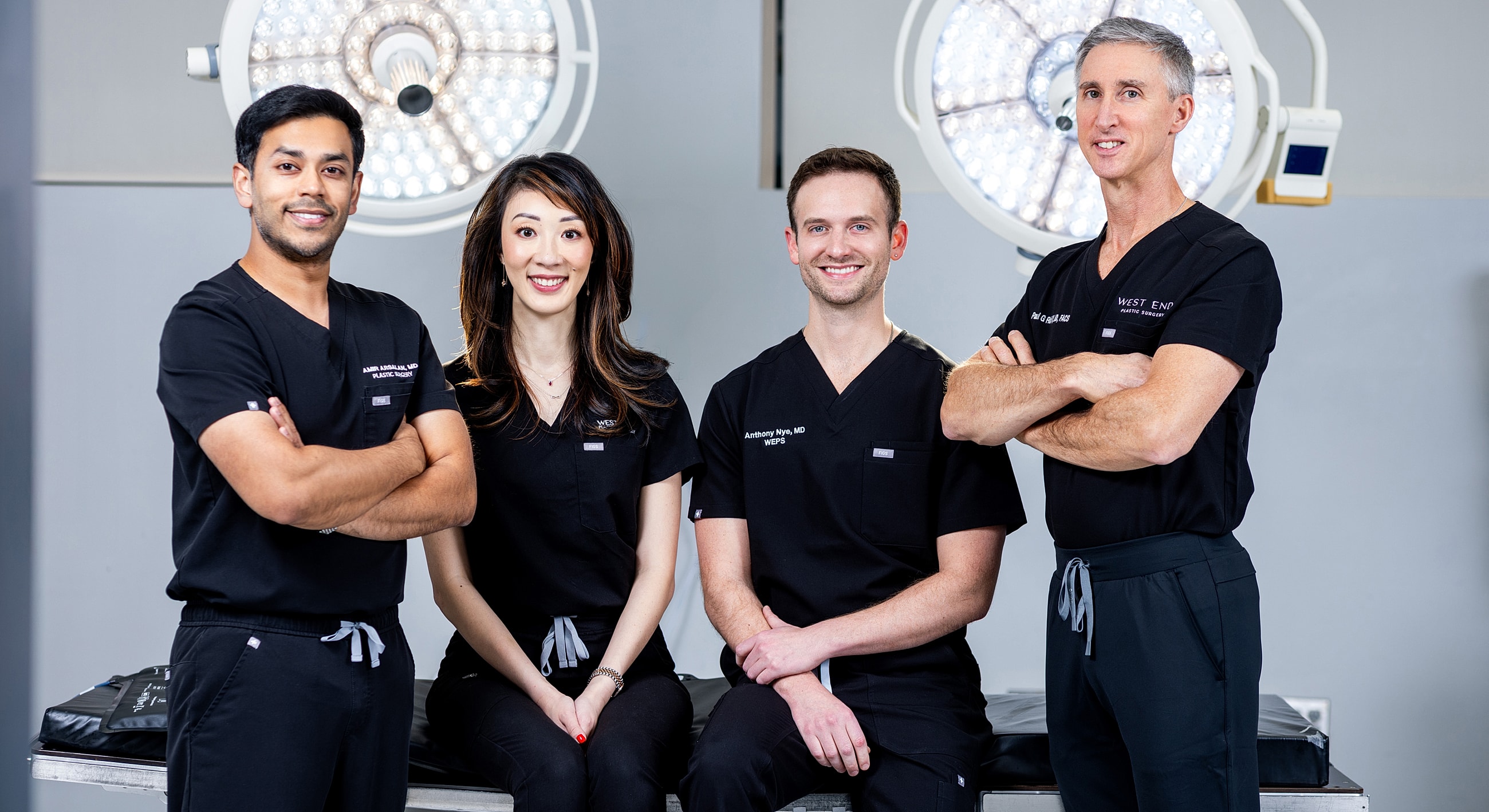 Medical professionals in scrubs posing together.