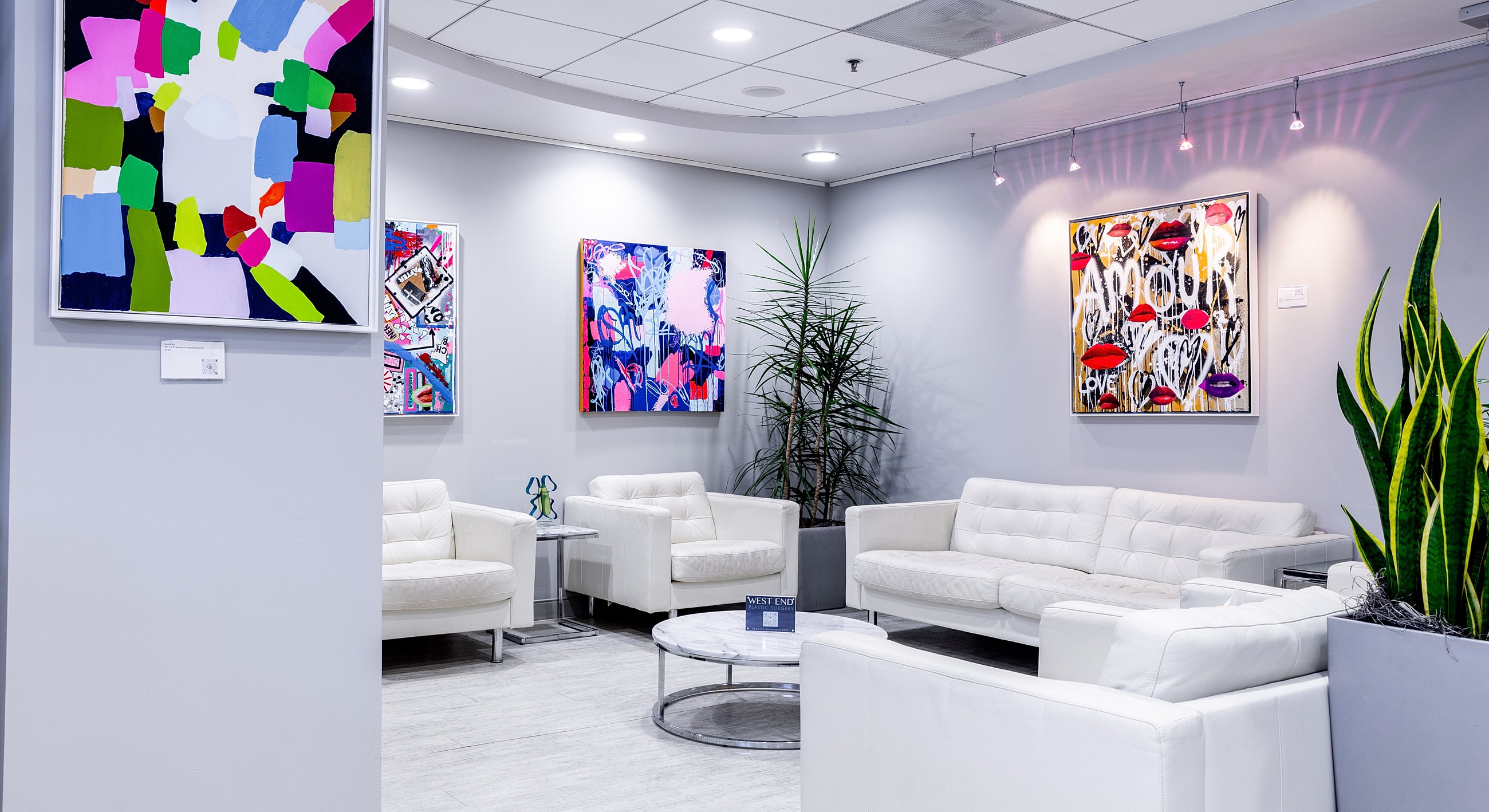 Modern lounge with colorful abstract artwork.