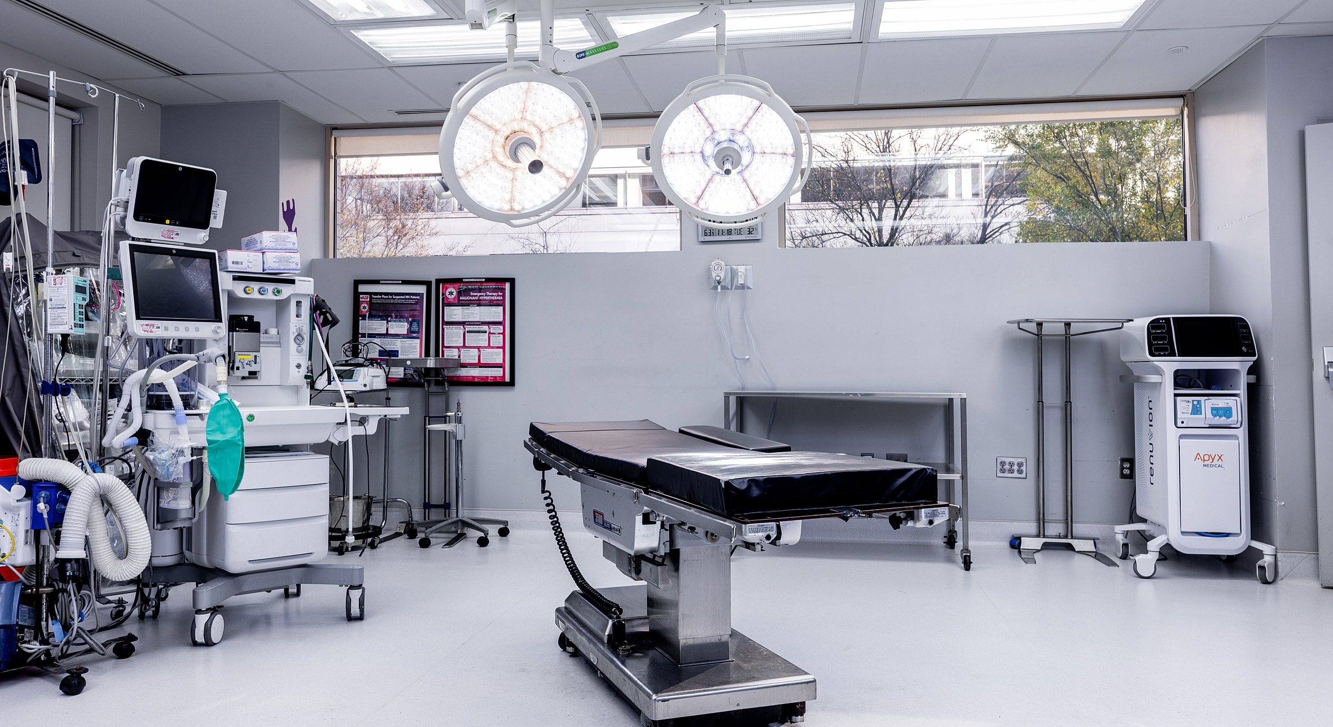 Modern surgical room with medical equipment and lights.