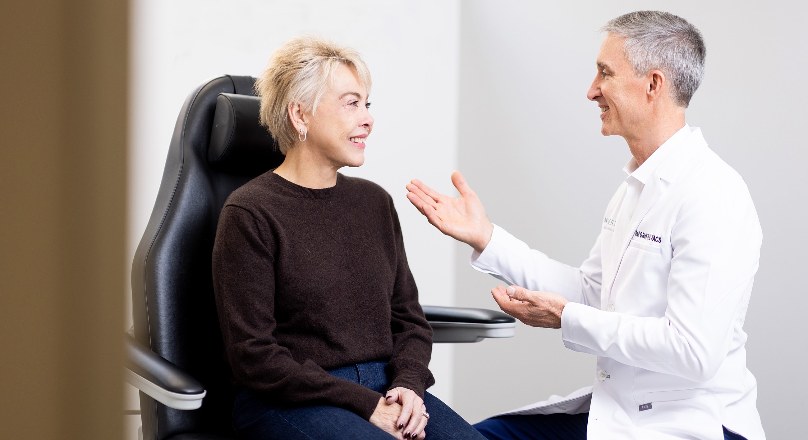 Patient consultation with doctor in office setting.