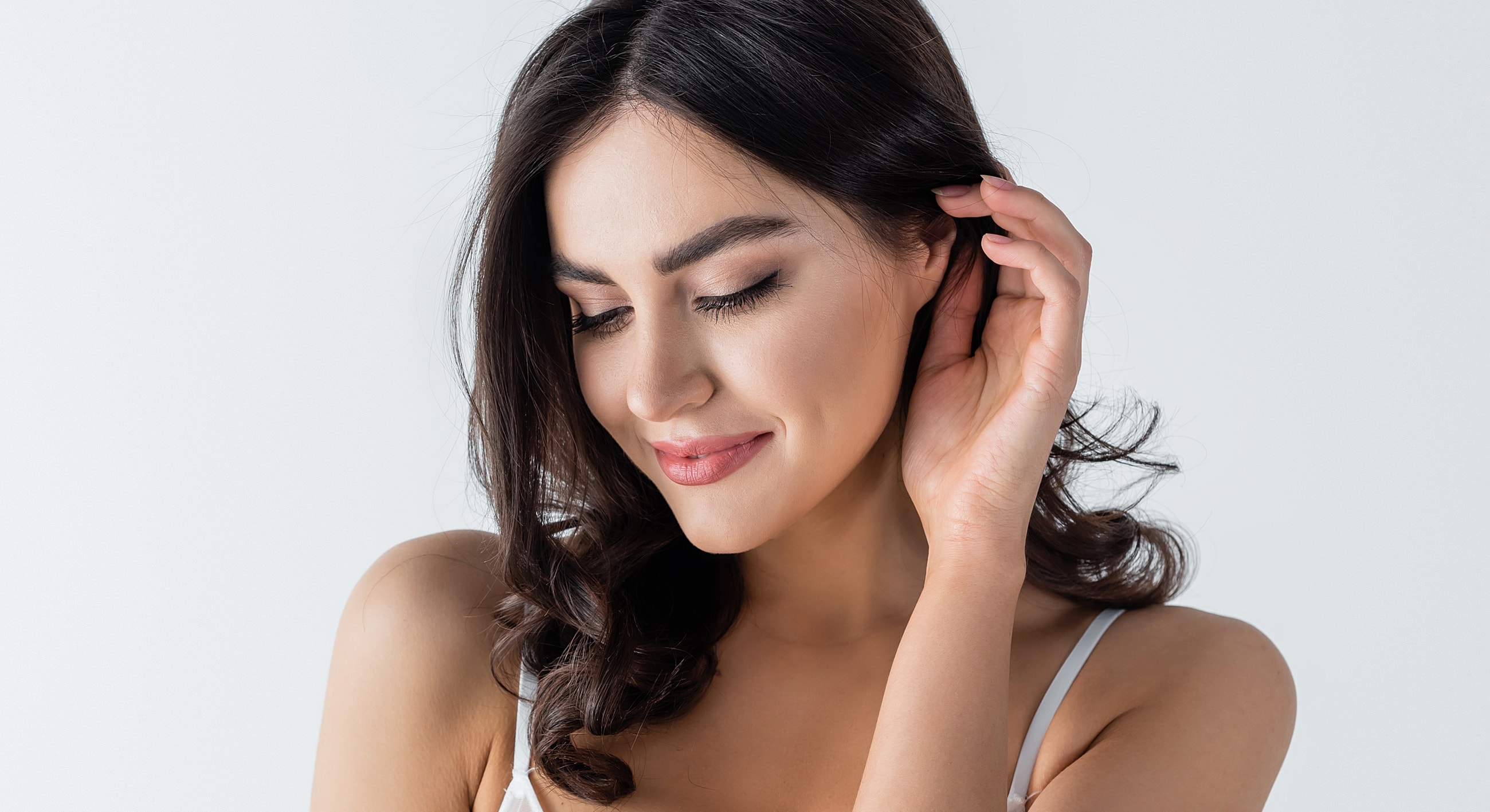 Smiling woman with long, dark hair.
