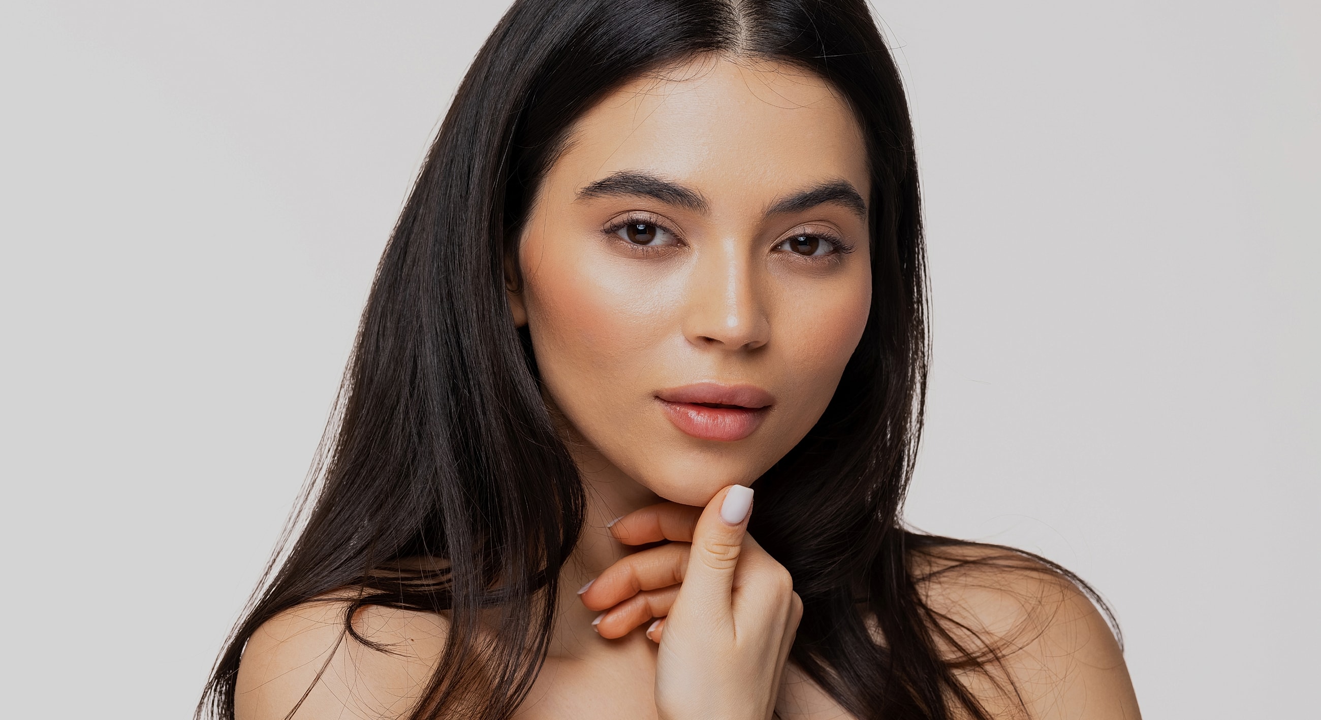 Woman with long hair and soft makeup.