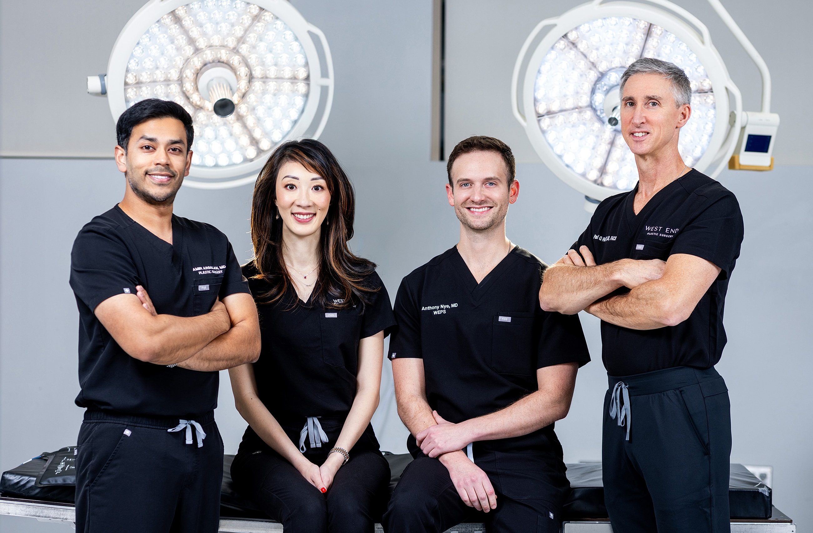Medical professionals in scrubs posing together.
