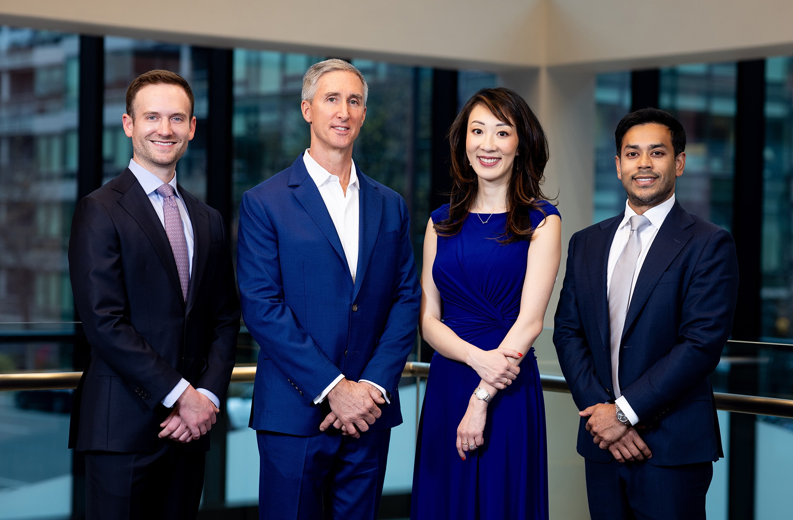 Professional group portrait of four individuals.