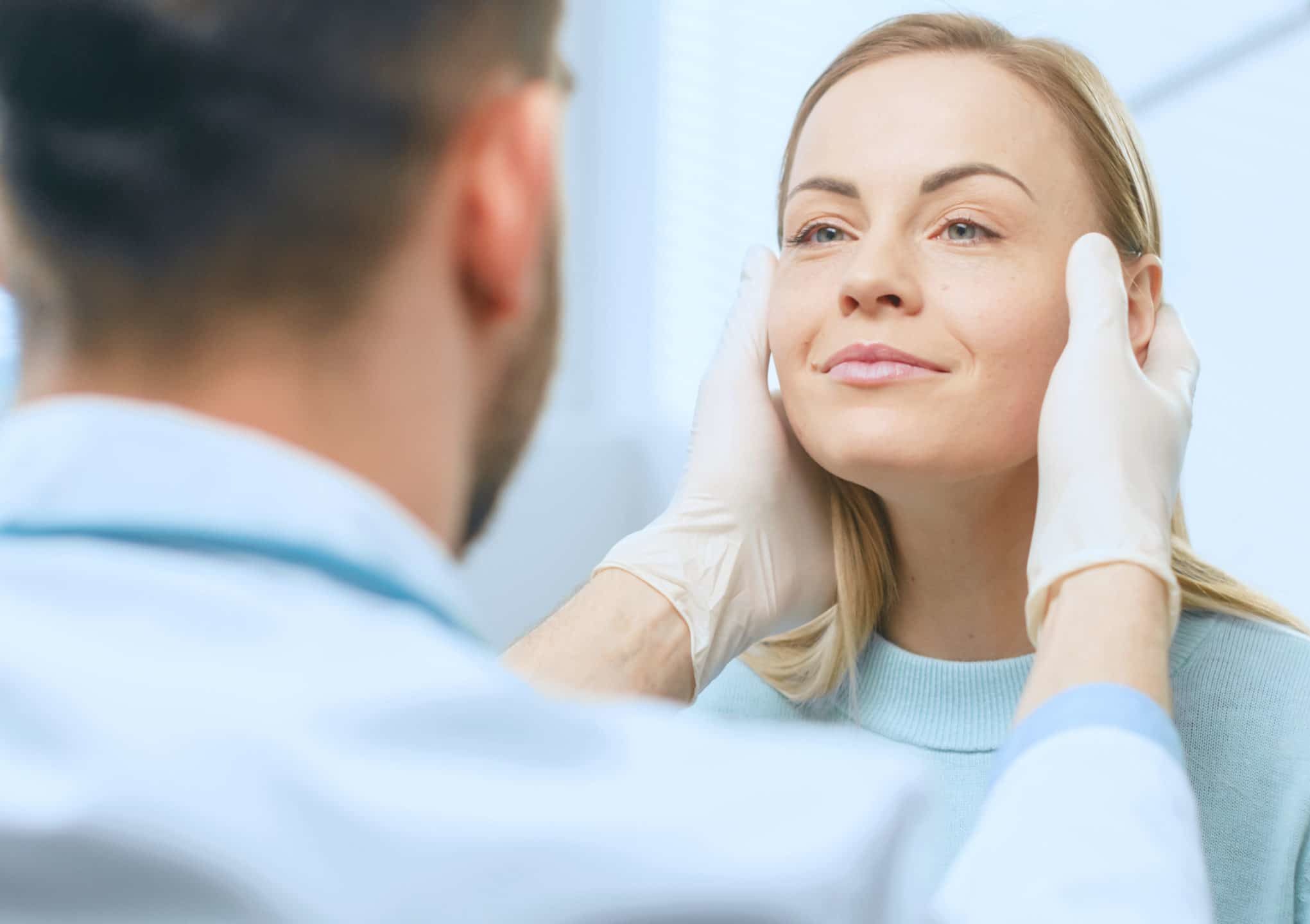 Plastic / Cosmetic Surgeon Examines Beautiful Woman's Face, Touches it with Gloved Hands, Inspecting Healed Face after Plastic Surgery with Amazing Results.