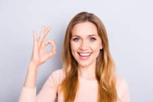 People body language facial emotion expressions people person concept. Close up portrait of excited lovely delightful cute confident manager making ok sign isolated on gray background coy-space