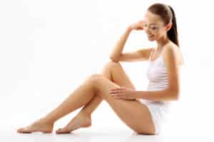 Woman sitting down with slim thighs from thigh liposuction in Washington, DC
