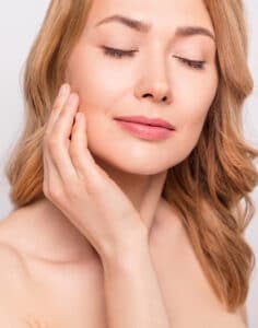 Side profile of a woman with a slim neck and defined chin from liposuction in Washington, DC