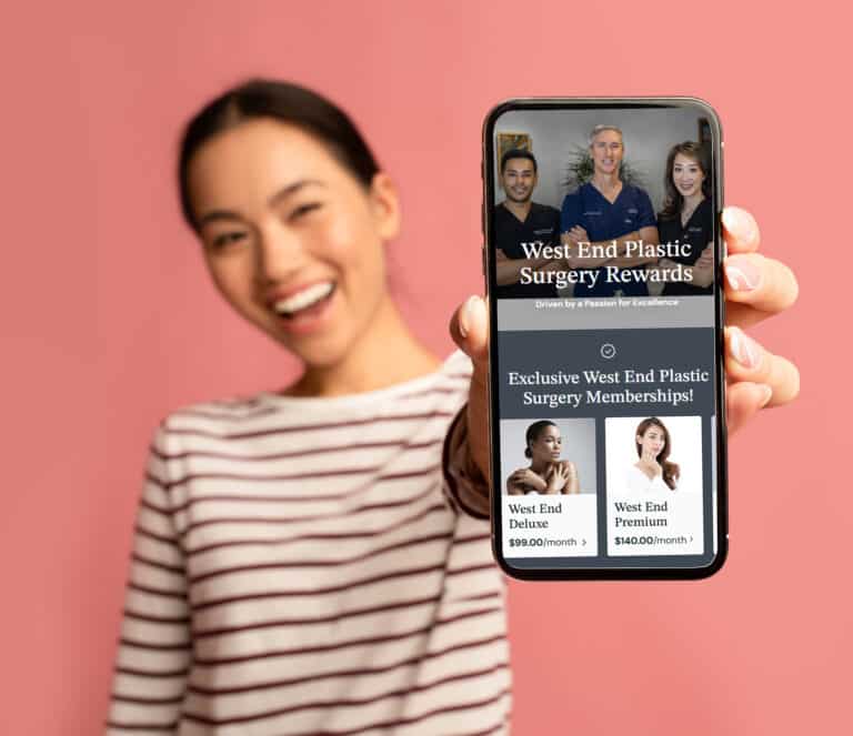 Great App. Cheerful Asian Female Demonstrating Smartphone With Blank White Screen